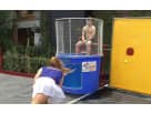 Blue and red dunk tank rental in Houston with mesh cage seat, ideal for interactive party entertainment in League City.