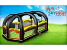 Football-themed inflatable obstacle course rental in Austin with multiple arched tunnels, perfect for Cedar Park backyard entertainment.