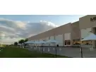White 10x10 high peak tent rental set up in Houston for outdoor events, accommodating up to 16 guests with elegant peaked design
