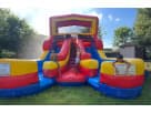 Red, blue, and yellow double water slide rental in Austin—wet or dry inflatable ideal for racing kids at backyard parties