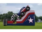 Patriot Monster Truck de 18ft en renta en Houston, perfecto para fiestas con tobogán acuático y diseño rojo, blanco y azul.