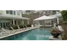 20x20 frame tent rental in Houston with clear side panels, perfect for poolside events in The Woodlands.