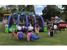 Blue and red interactive bounce house rental in Austin with multiple challenge stations, ideal for sports-themed parties in San