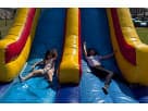 Dual-lane obstacle course rental in Austin with rock climb and slides, ideal for Buda birthday parties.