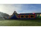 Perfect for Austin parties, this 60ft obstacle course rental features dual slides, pop-ups, and rock climbs ideal for Buda events.