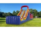 Red, yellow, and blue 60ft obstacle course rental in Austin with dual slides, ideal for Buda birthday parties and outdoor events.