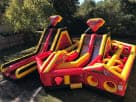 Superhero obstacle course rental in Austin with dual slides and climbing wall, ideal for Kyle birthday parties.