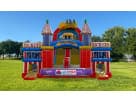 Colorful castle bounce house with dual towers and slide rental in Austin, perfect for all-ages obstacle course parties