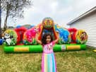 Animal Kingdom toddler bounce house with panda and tiger characters in a Dallas backyard—colorful inflatable rental