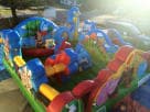 Toddler Animal Kingdom bounce house rental in Dallas with colorful blue, red, and green sections, ideal for Plano birthday