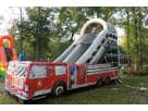 Fire truck bounce house with spiral slide rental in Austin, ideal for birthday parties and all ages.