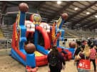 Red and blue basketball-themed bounce house rental in Austin with slide, ideal for Round Rock parties.