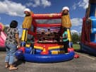 Batters Up inflatable baseball game rental in Austin with dual yellow cornstalk towers, ideal for kids' birthday parties in Buda.