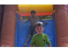 Colorful 3-in-1 bounce house with dual climbing walls and water slide rental in Houston, perfect for backyard parties in Sugar
