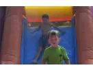 Colorful 3-in-1 bounce house with dual climbing walls and water slide rental in Houston, perfect for backyard parties in Sugar