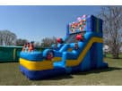 Birthday cake-themed water slide rental in Houston with wet or dry slide option, set up on grass—ideal for kids' parties