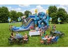 n outdoor children's party featuring a massive robot-themed inflatable slide with lightning bolt pillars. The setup includes themed blue and yellow balloon bouquets, a "Happy Birthday" banner, and several dining tables for guests. This premium party attra