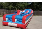 Perfect for Austin parties, this red and blue obstacle course rental features multiple tunnels ideal for teenagers and adults