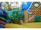 Colorful candy-themed toddler bounce house rental in Austin backyard with gingerbread house design, ideal for Round Rock parties.