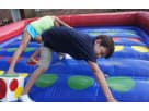 Inflatable Twister interactive game rental in Austin with colorful rainbow design, perfect for Cedar Park birthday parties