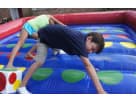 Interactive Twister bounce house rental in Houston with numbered spots and hand placements, perfect for The Woodlands birthday