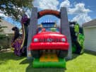 Perfect for Cedar Park toddlers, this dinosaur-themed obstacle course rental in Austin features a slide, ball pit, and bright