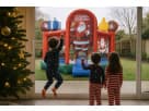 Santa-themed bounce house rental in Austin with basketball goal inside, ideal for Christmas parties in Round Rock.