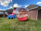 Christmas snow globe bounce house rental in Austin with LED lights, perfect for holiday parties in San Marcos.