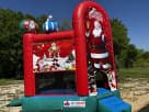 Santa Claus bounce house rental in Houston with dual towers and slide — ideal for The Woodlands Christmas parties.