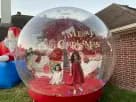 Christmas inflatable snow globe rental in Austin with festive lights—ideal for Buda holiday parties.