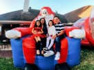 Giant inflatable Santa Chair rental in Houston with armrests, perfect for holiday photo ops in League City events.