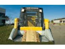 Yellow and gray skid loader bounce house rental in Austin with dual climbing ramps, ideal for construction-themed birthday