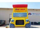 Giant yellow and red dump truck bounce house rental in Dallas with wet or dry combo feature, ideal for McKinney parties.