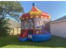 Carousel bounce house rental in Houston featuring a bright yellow roof, ideal for Cypress birthday parties.