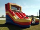 Perfect for Dallas summer parties, this red, yellow, and blue 16ft double water slide rental features dual slides and climbing