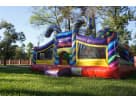 Colorful candy-themed toddler bounce house rental in Dallas backyard with multiple turrets and slides, ideal for Irving