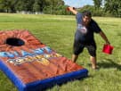 Giant inflatable cornhole rental in Dallas with two boards—perfect for Arlington team building events and outdoor parties.