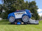 Renta de brincolín Police Cruiser con tobogán ideal para fiestas en Dallas y Mesquite, perfecto para niños con diseño azul