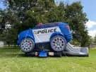 Perfect for Dallas birthday parties, this police cruiser bounce house rental features a slide and bouncing arena for kids ages