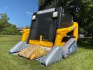 Construction-themed Skid Loader bounce house rental in Dallas with dual slides, perfect for kids' parties in Grand Prairie.