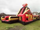 Perfect for Lewisville birthday parties, this red and yellow obstacle course rental in Dallas features dual lane slides
