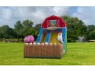 Dallas farm water slide rental features vibrant blue and yellow inflatable with friendly pig character for Arlington gatherings.