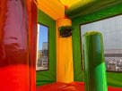 Colorful 2-lane fiesta bounce house combo with wet/dry slide option for Austin birthday party rentals, ideal for Buda.
