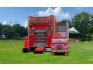 Fire Station bounce house rental with dual slides at an Austin park, perfect for wet or dry party entertainment in Kyle.