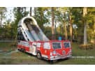 Red and white fire truck bounce house with tall slide available for rental in Dallas, ideal for Mesquite birthday parties and all