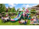 Perfect for Houston parties, this pink floral bounce house rental features a dual slide design ideal for wet or dry play