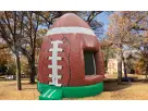 Football bounce house rental in Austin park with green base, perfect for all ages and holds up to 5 kids.