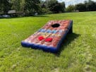 Perfect for Dallas team building events, this giant inflatable cornhole rental features 5-foot width ideal for competitive