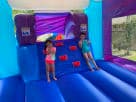 Perfect for Dallas parties, this Disney Frozen 2 bounce house rental features a wet or dry slide with blue and purple design