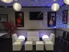 White leather modular seating rental in Houston with purple and blue lighting, ideal for Kingwood parties.